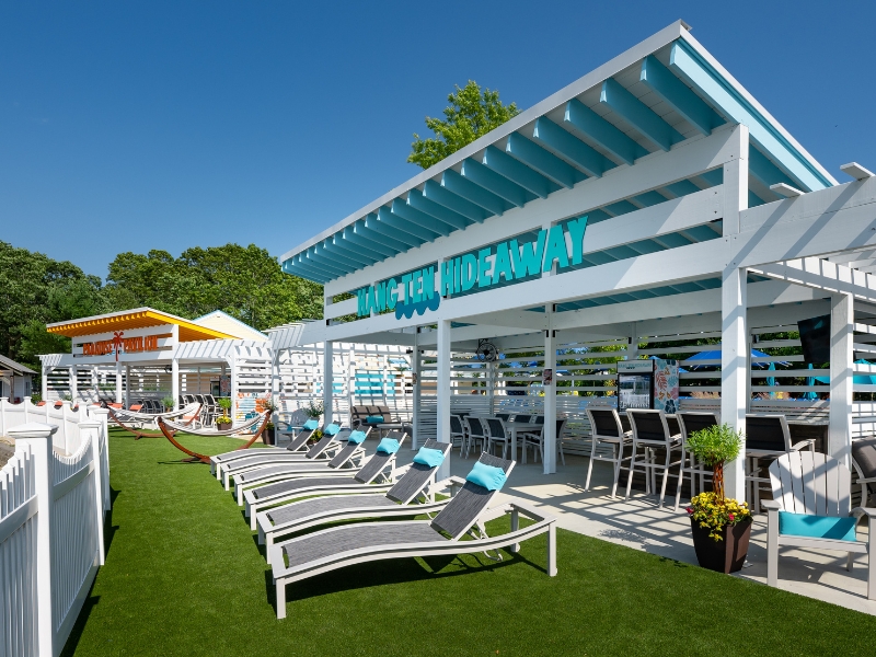 White cabana buildings in front of wavepool