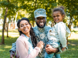 Dad in military uniform with child and wife