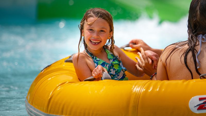 child smiling and enjoying the wave pool